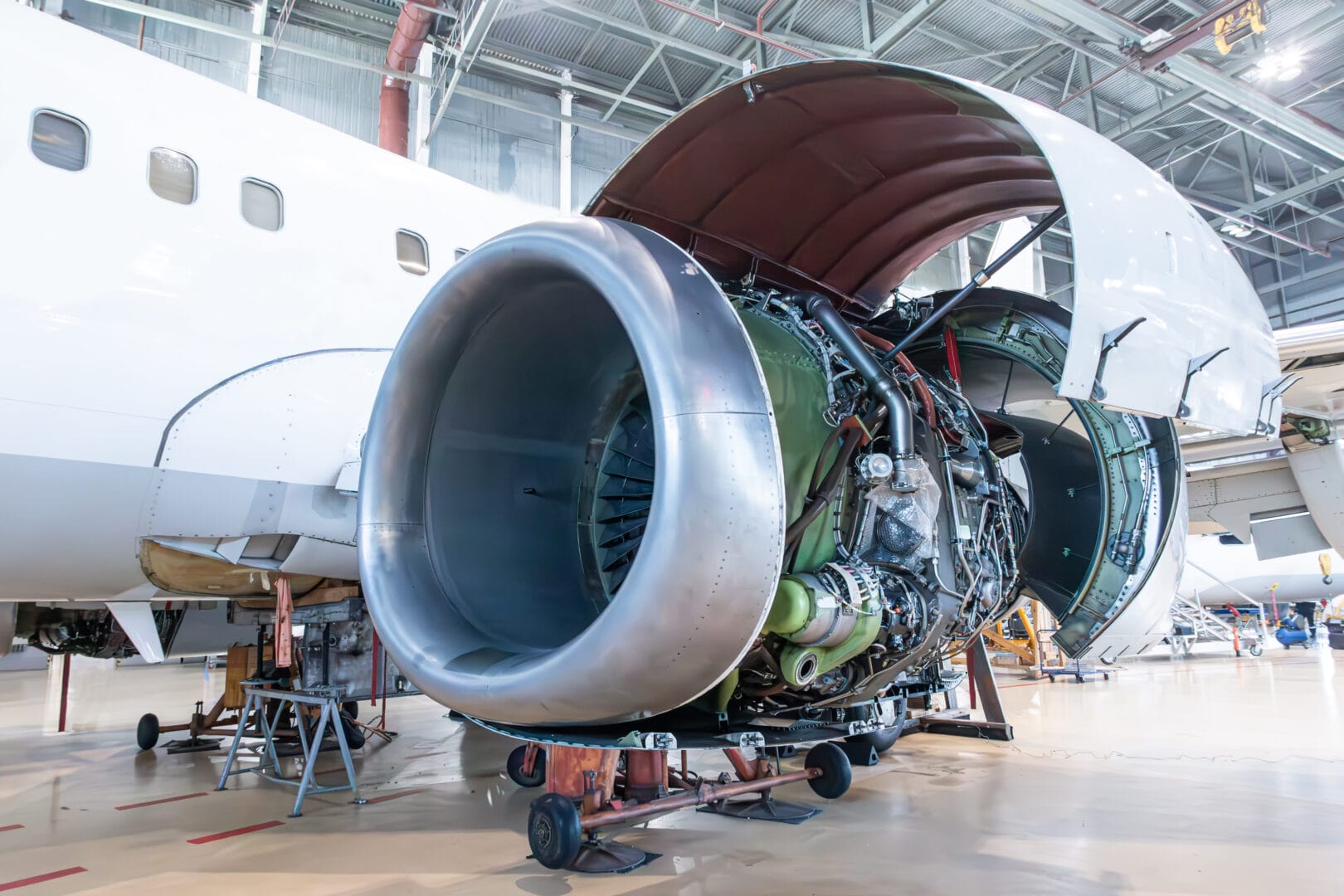 Close-up of an open high bypass turbofan airplane engine in aircraft hangar