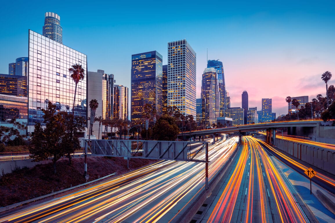 Los Angeles skyline during rush hour, with long-exposure applied to traffic