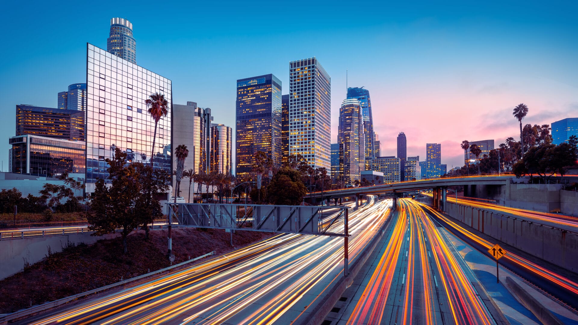 Los Angeles skyline during rush hour, with long-exposure applied to traffic